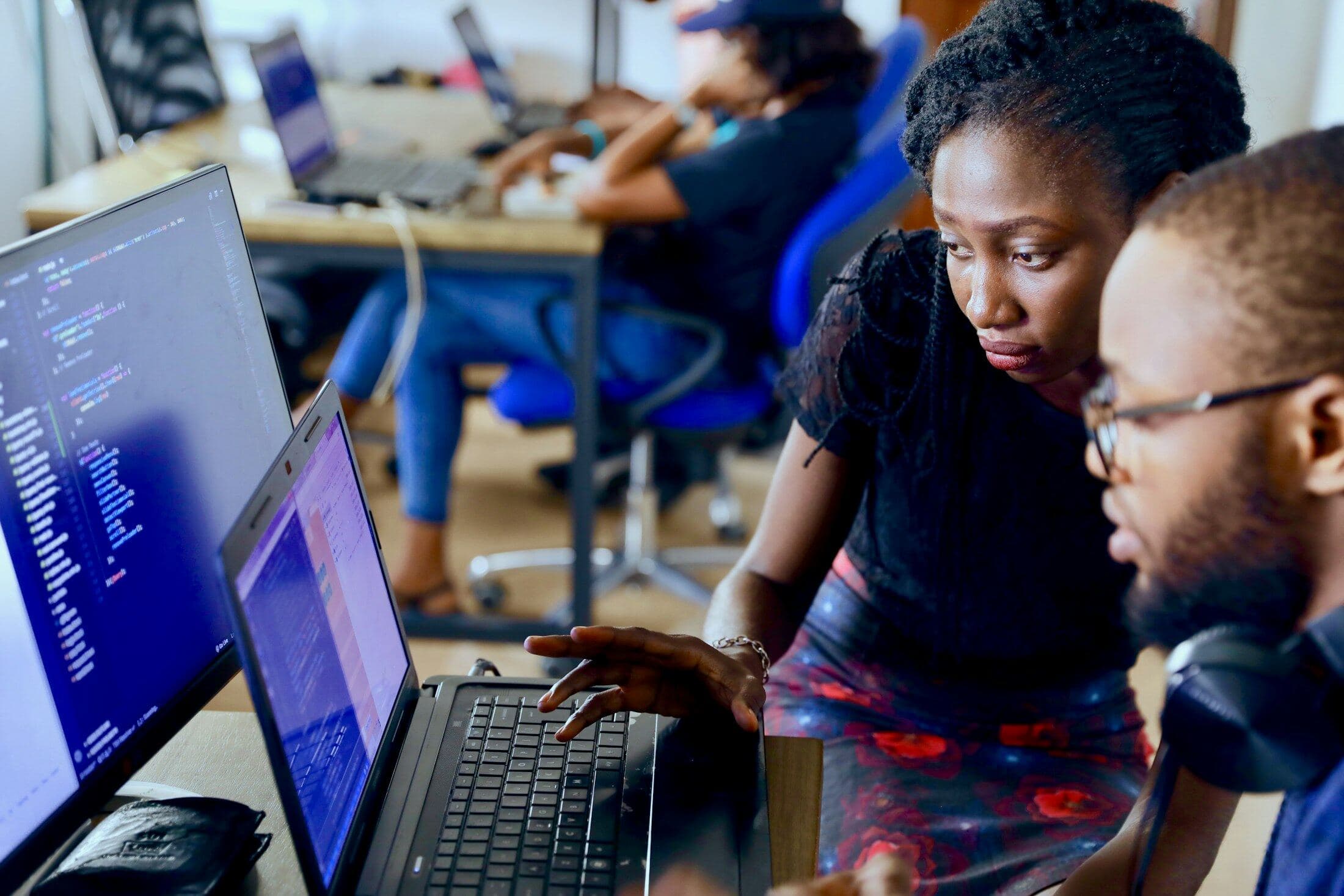 Two developers reviewing code together at a desk