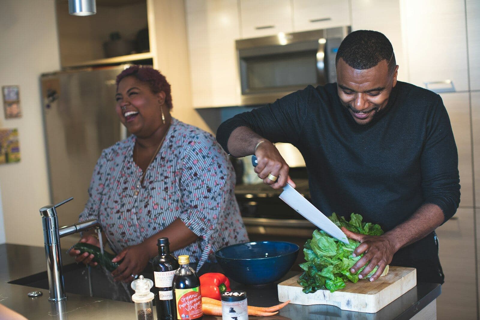 Two people cooking together in a home kitchen